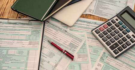 detail of the notebook on which the pen stands, from the side of notebooks and tax forms 1040. The...