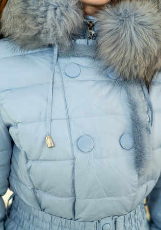 stylish woman wore a warm beautiful jacket to avoid catching a cold. Women's outerwear conceptの写真素材