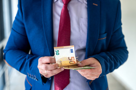 businessman hands counting euro money, close up. bribe, salary or shopping conceptの写真素材