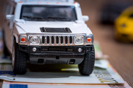 toy car, euro bill on deskの写真素材