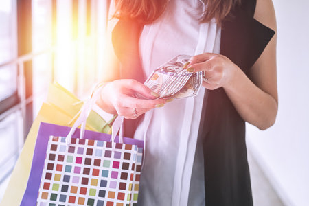 woman cound dollar after shoping crazy black friday. discount conceptの写真素材