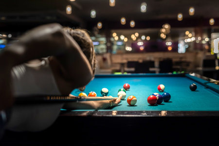 pretty lady take to easy shoot to win in billiards game. pleasantly spent free time