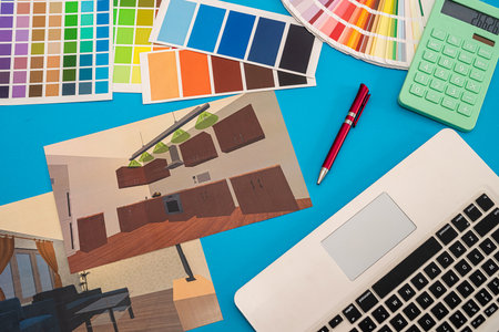 plan of house with colored patterns for repair with laptop on office desk. renovation