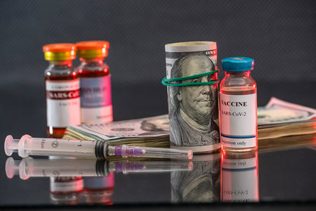 colored jars of coronavirus vaccine stand on the table. Vaccination concept during a pandemicの写真素材