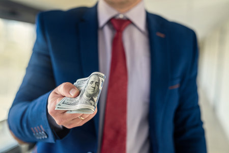 happy businessman holding lots of dollars after success deal. finance conceptの写真素材