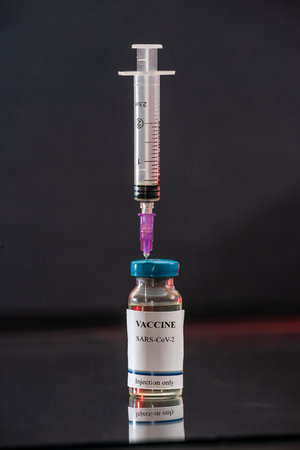 flasks with a transparent vaccine are waiting for re-vaccination for city residents. The concept of revaccinationの写真素材
