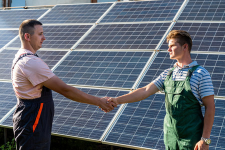 Two man finished installation of new solar panel station. green concept energyの写真素材