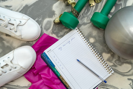before training, the coach spread out sports equipment and a notebook with a pen. The concept of sports goals. Goal concept in sportの写真素材