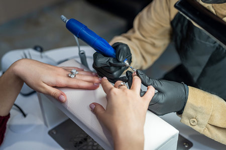 a beautiful client came to the beauty salon for a new manicure during the pandemic. Manicure concept during quarantineの写真素材