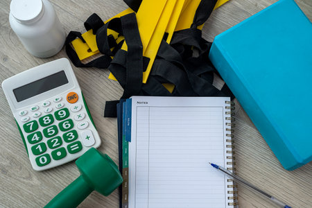 sneakers kettlebell water notebook on sports mat lie. Sports equipment concept