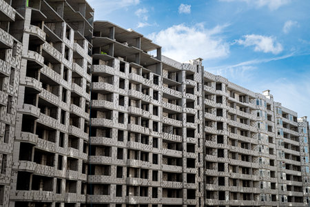 new beautiful buildings under construction stand on a background of beautiful sky. construction conceptの写真素材