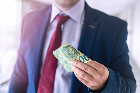 happy businessman hold euro money after success deal. salary or bribe concept. shoppingの写真素材