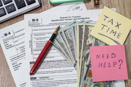 Form w4, w9 is empty to fill with money dollars on the table. Document conceptの写真素材