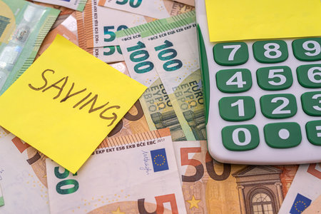 text salary saving in memo with calculator and euro money. financial conceptの写真素材