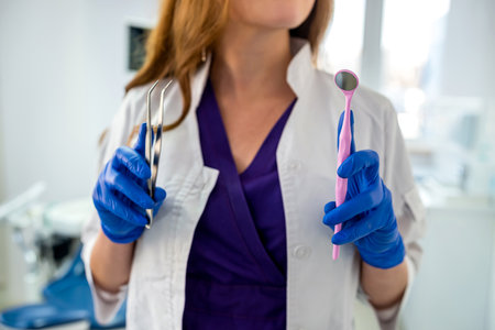 Young pretty female dentist stomatology in uniform and gloves at workplace cabinet. healthcare. friendly doctorの写真素材