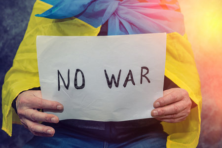 No war written on a poster that a man holds in Ukraine.の写真素材