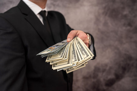 100 dollar us cash in hand savings profit. money conceptの写真素材
