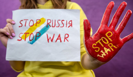 all world against the war. russia international terrorist. stop war red paint at female handsの写真素材