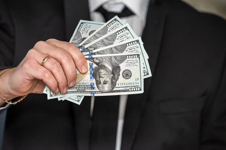 man in suit counting us money dollar, savings and finances conceptの写真素材