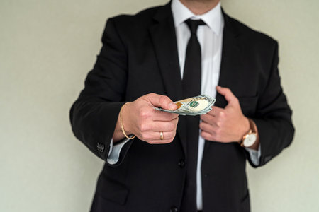 man in suit counting us money dollar, savings and finances conceptの写真素材