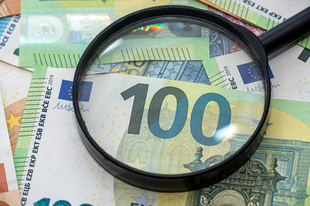 concept of inflation in Europe, euro money with magnifying glass. financeの写真素材