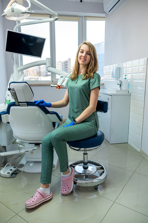 Portrait of pretty female dentist in uniform at dental clinic.の写真素材