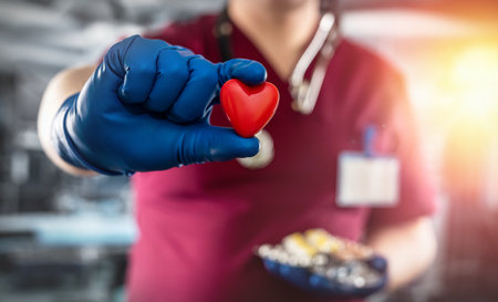 Doctor in red uniform holding medicine drugs in hospital room. concept of generic pillsの写真素材