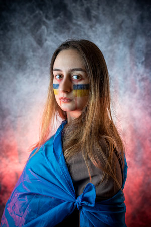 protest against the war, the Ukrainian woman in the national flag shows all the emotions and hope for peaceの写真素材