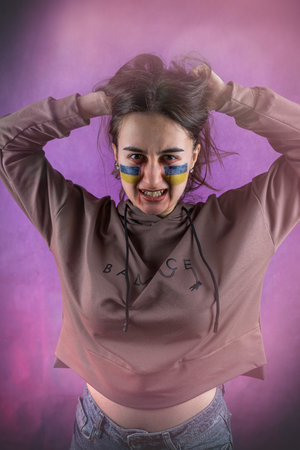 protest against the war, the Ukrainian woman in the national flag shows all the emotions and hope for peaceの写真素材