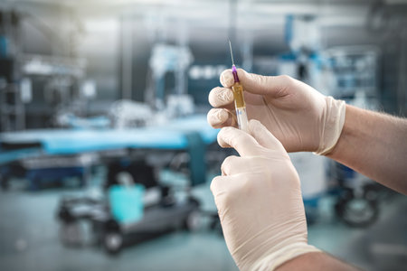 hands of medical assistant wear gloves and preparing syringe for inject anesthesia preparing for surgery in the surgical office at the hospitalの写真素材