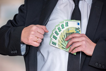 Business man wear black suit holding euro bills. money conceptの写真素材