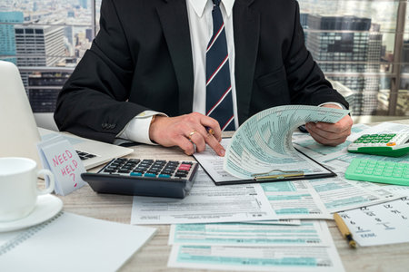 businessman working with documents 1040 tax form in office. Concept of accounting financial annual reportの写真素材