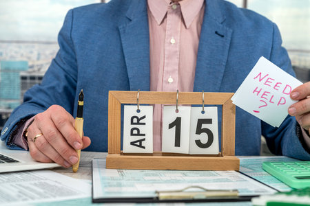 Businessman making calculation financial annual report and after fill 1040 tax form. Concept of working with documents in the officeの写真素材