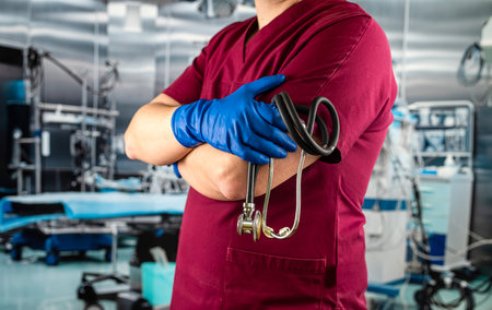 doctor or nurse in red uniform with stethoscope standing at emergency room. healthcare and medicineの写真素材