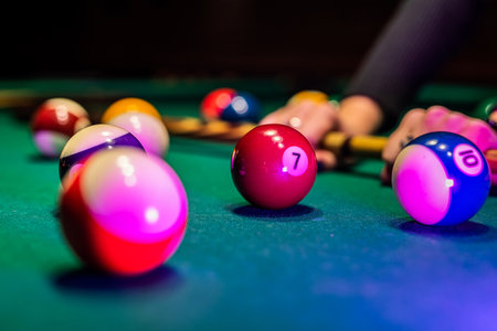 Old billiard ball and stick cue on a green table. Billiard balls concept isolated on green tableの写真素材