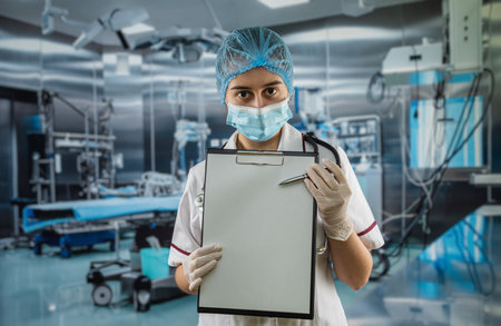 female doctor in white coat uniform showing empty clipboard to write for record patient diagnosis in modern room clinicの写真素材