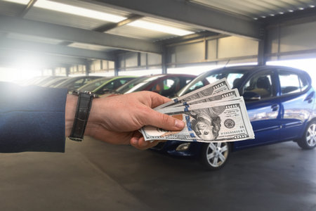 large costs of a large serious boss for the car after breakdown and keys and car after repair. Expensive car repair conceptの写真素材