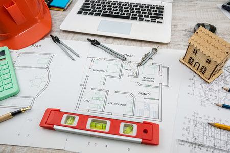 house project plan with work tools and helmet on desk. industrial concept