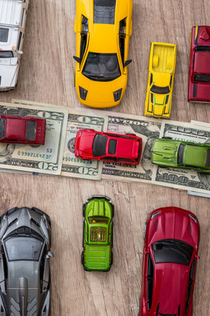 many toy cars on dollar as road.の写真素材