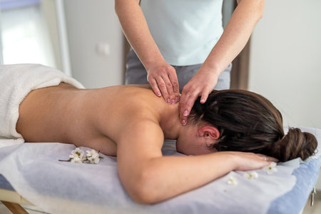 beautiful woman in spa salon. Concept of traditional massage therapyの写真素材
