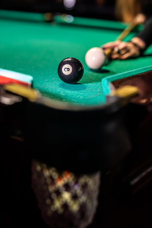 Billiard balls on the table and the player's hands are preparing to strike in the start mode. indoor...