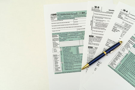Tax Form 1040 per tax year for individual US tax returns with a pen next to it. The concept of tax formsの写真素材