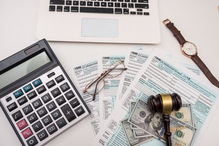 1040 individual tax form with gavel and dollars bills on desk, annual reportの写真素材