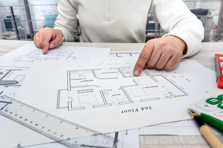 a professional architect makes a custom sketch of an apartment building in a large complex. Male...