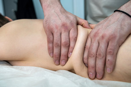 young slim woman having relaxing massage on back in spa. performing wellness treatments