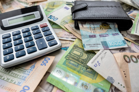 exchange of US dollars to Ukrainian hryvnias on the table with a calculator. Exchange rate concept