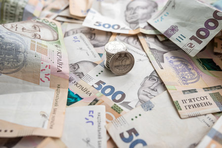 new 500 1000 Ukrainian hryvnia banknotes and coins as background. Ukrainian national currency bills....