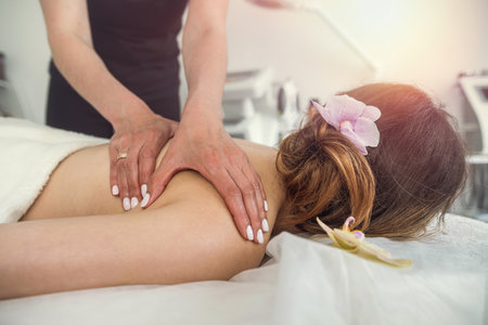 Pretty woman having back massage in spa, health lifestyleの写真素材