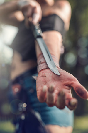 sharp knife in female hand at outdoor, warriorの写真素材