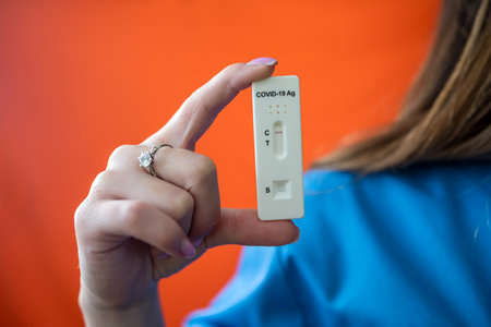 Young female medical worker holding pills in hands isolated on white background. Doctor woman...